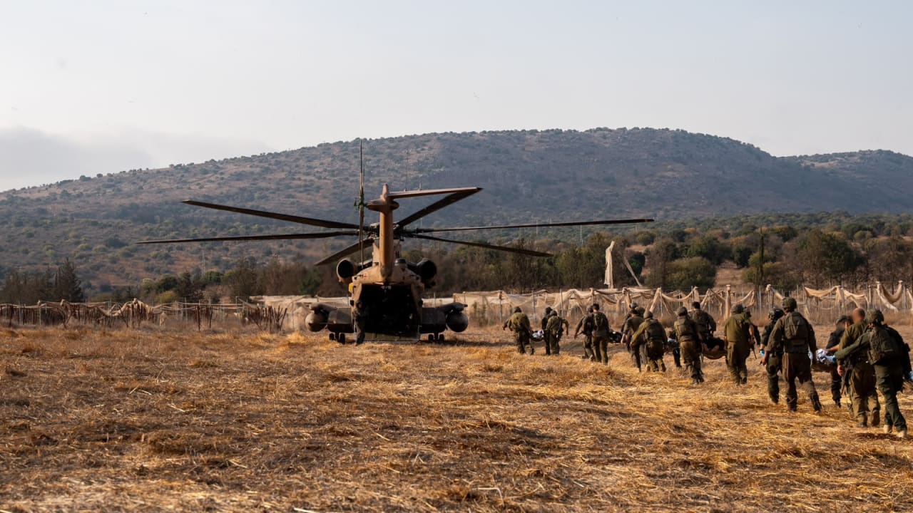 IDF helicopter and soldiers evacuating the wounded