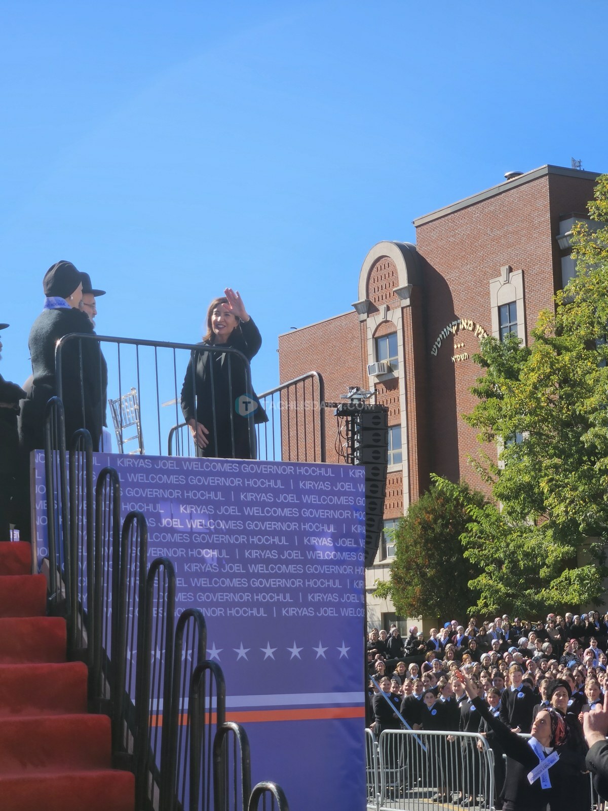 Gov. Kathy Hochul waves to the crowd in Kiryas Joel